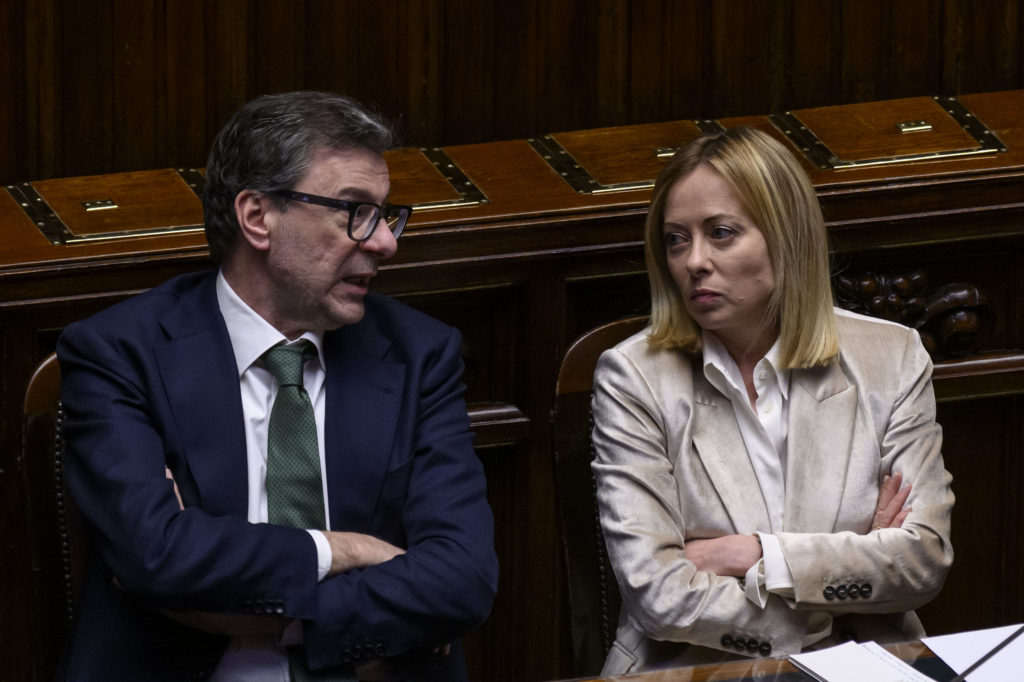 ROME, ITALY - MARCH 19: Italian Minister of Economy and Finance Giancarlo Giorgetti speaks with Italian Prime Minister Giorgia Meloni as she reports to the Chamber of Deputies ahead of the European Council meeting, on March 19, 2025 in Rome, Italy. (Photo by Antonio Masiello/Getty Images)